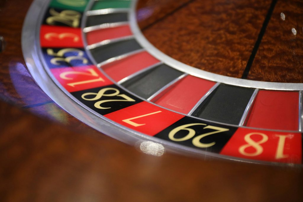 pexels-photo-3894215-3894215 A detailed closeup of a roulette table displaying numbers and colors in a casino setting.